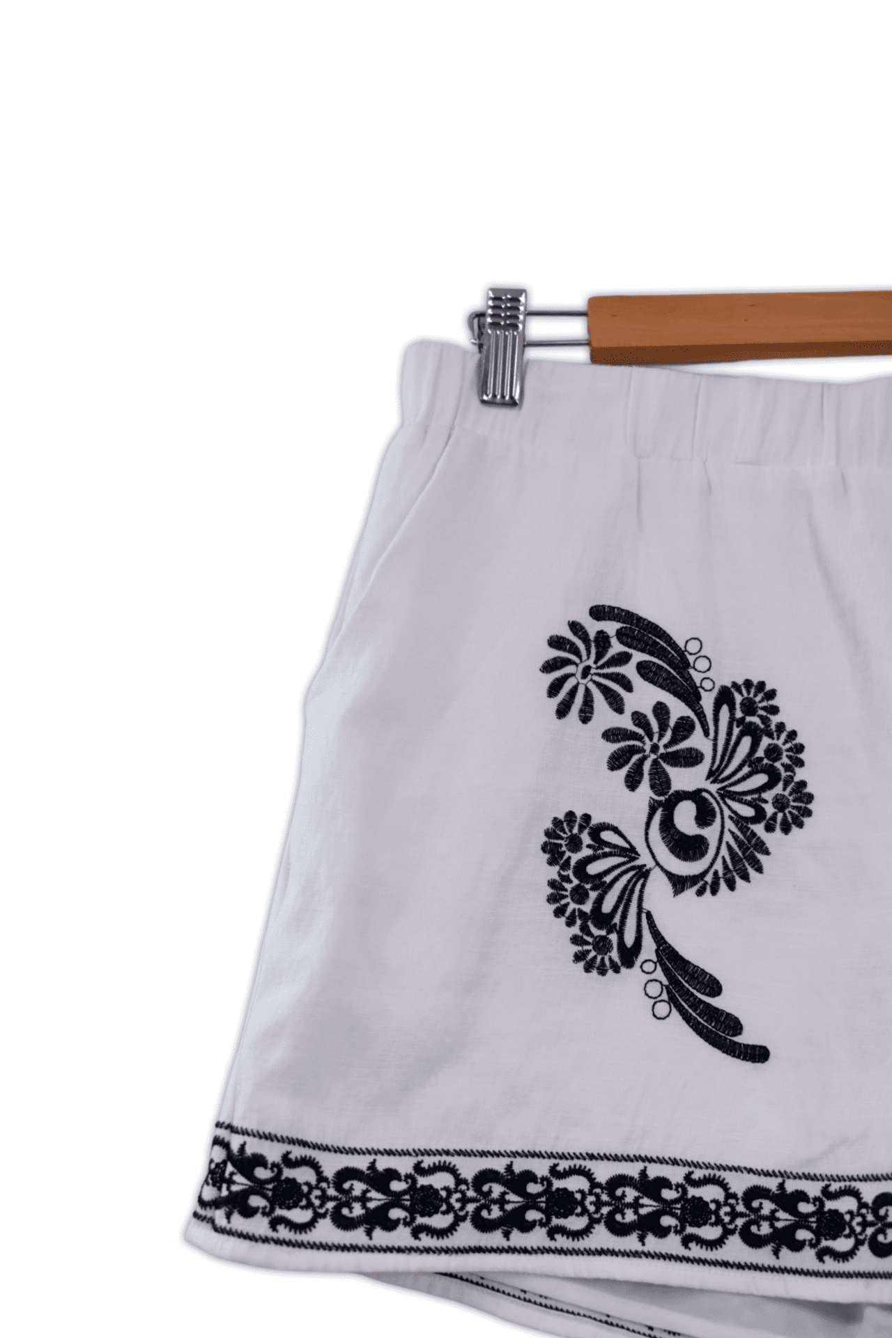 Lightweight summer shorts featuring floral embroidered patterns on the front and along the hemline. The shorts are also a medium size with an elastic waist band.