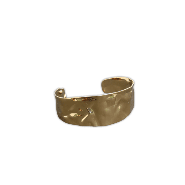Cuff-like, hammered metal bracelet with a textured gold finish.