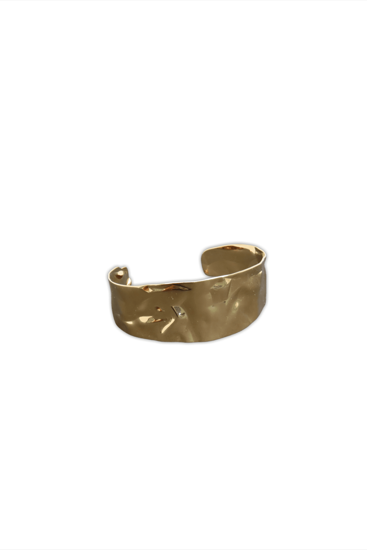 Cuff-like, hammered metal bracelet with a textured gold finish.