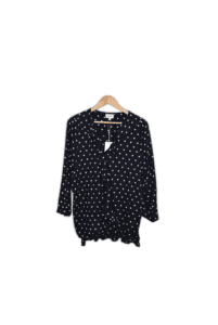 Wrap style blouse with ruffled v-neckline, long sleeves and a bold spot print. 