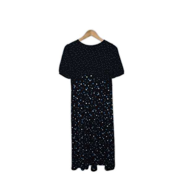 Soft dress featuring an empire waistline, gathered cap short sleeves and a midi skirt length. Medium. Black with blue dots