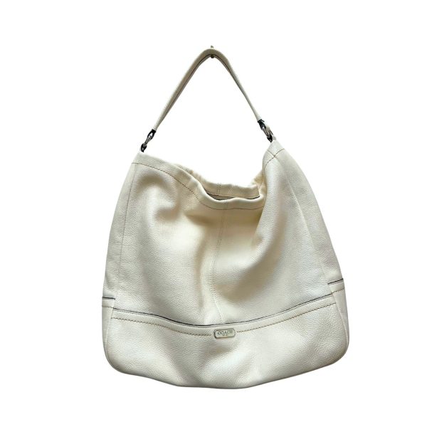 White Coach hobo bag with a single shoulder strap.